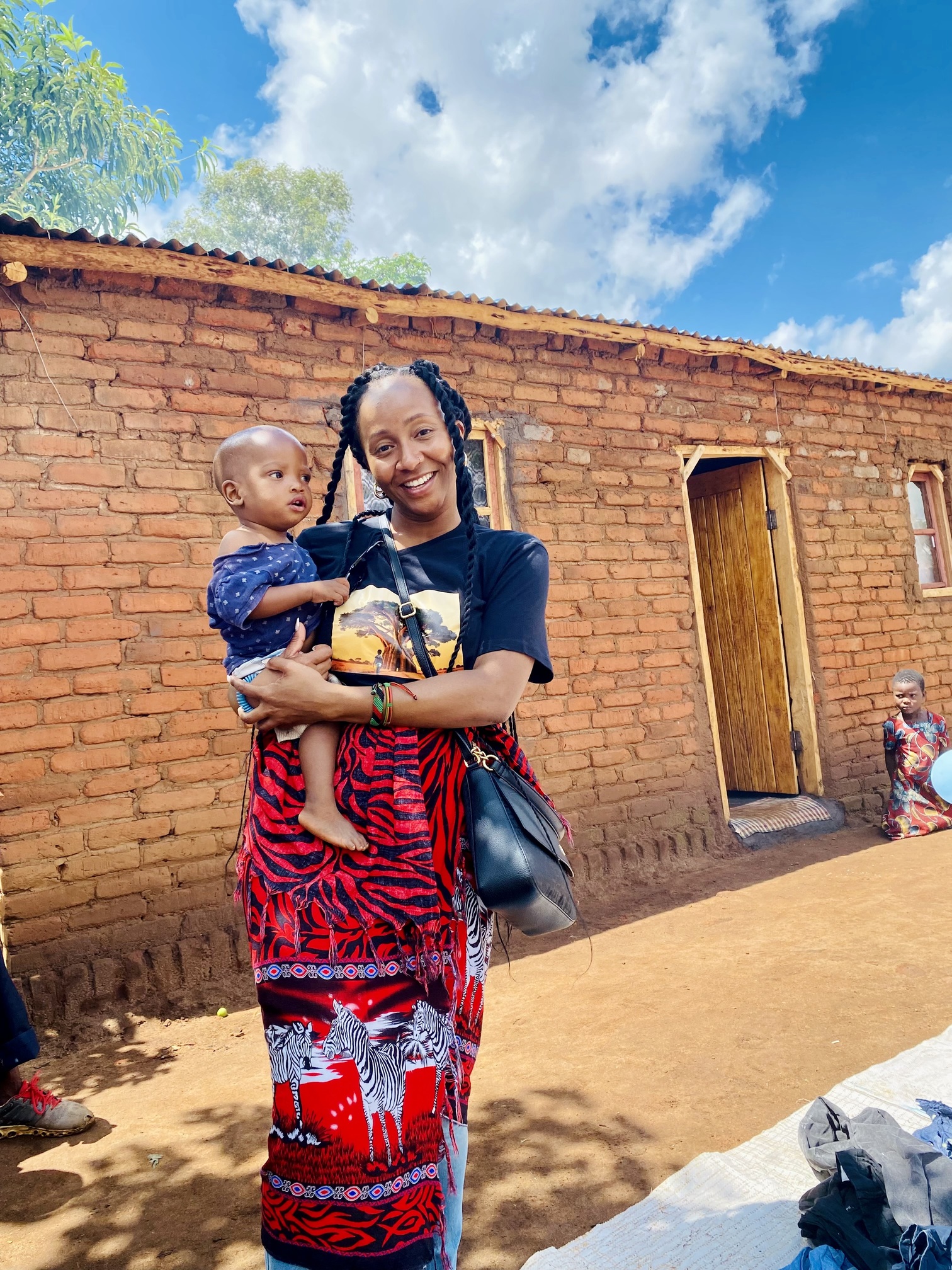 Founder holding a small child